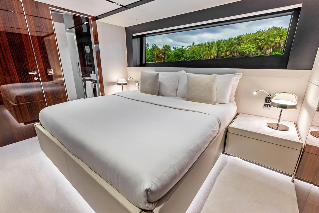 The stateroom offers a luxurious and serene retreat with a large bed and a scenic window view. aboard EURO Yacht for Sale