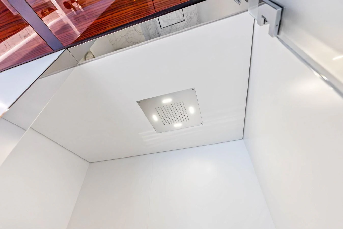 A sleek, modern shower with a square overhead rain showerhead. aboard EURO Yacht for Sale