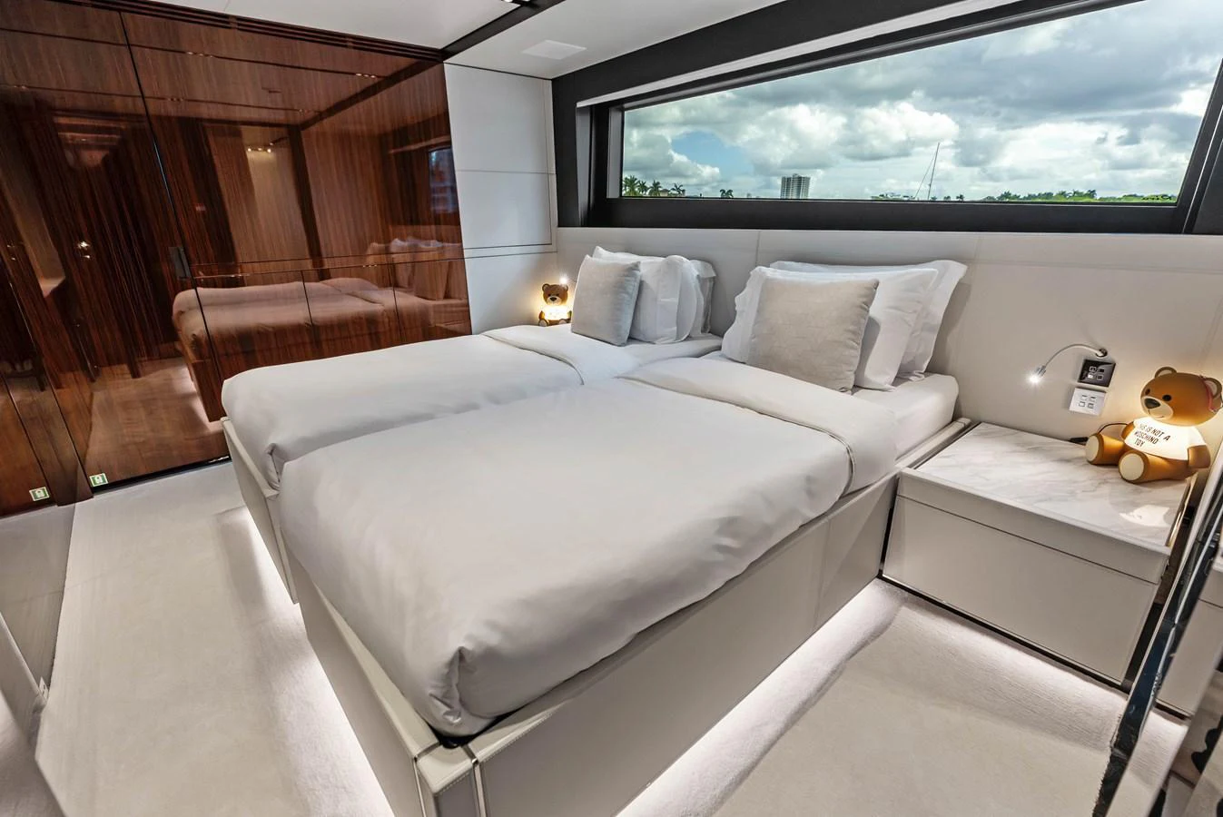 The guest stateroom features twin beds with luxurious bedding and modern decor. aboard EURO Yacht for Sale