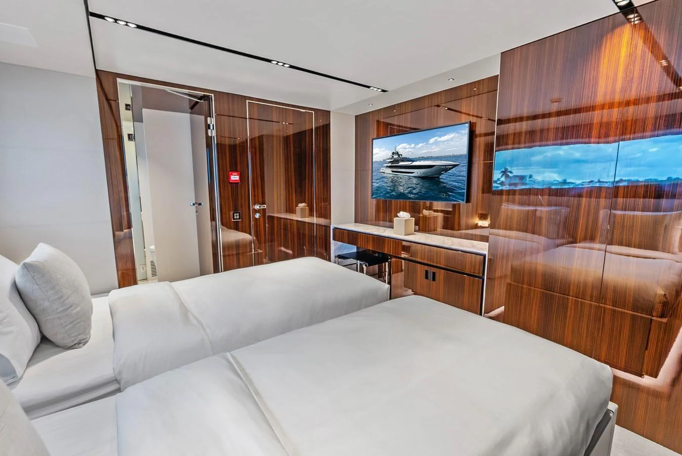 The guest stateroom features twin beds, a sleek wooden finish, and a flat-screen TV for entertainment. aboard EURO Yacht for Sale