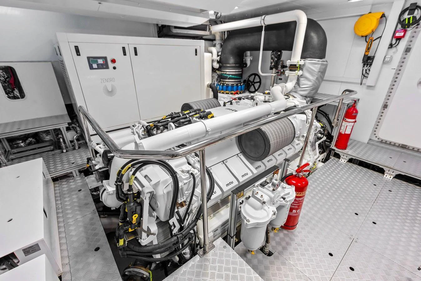The image showcases a pristine engine room with well-maintained machinery and safety equipment. aboard EURO Yacht for Sale