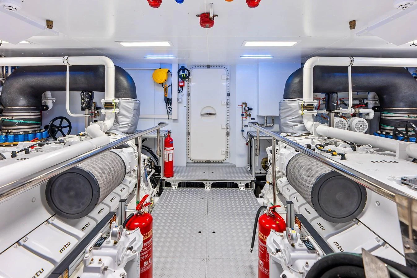 The image showcases a pristine and well-organized engine room with advanced machinery and safety equipment. aboard EURO Yacht for Sale