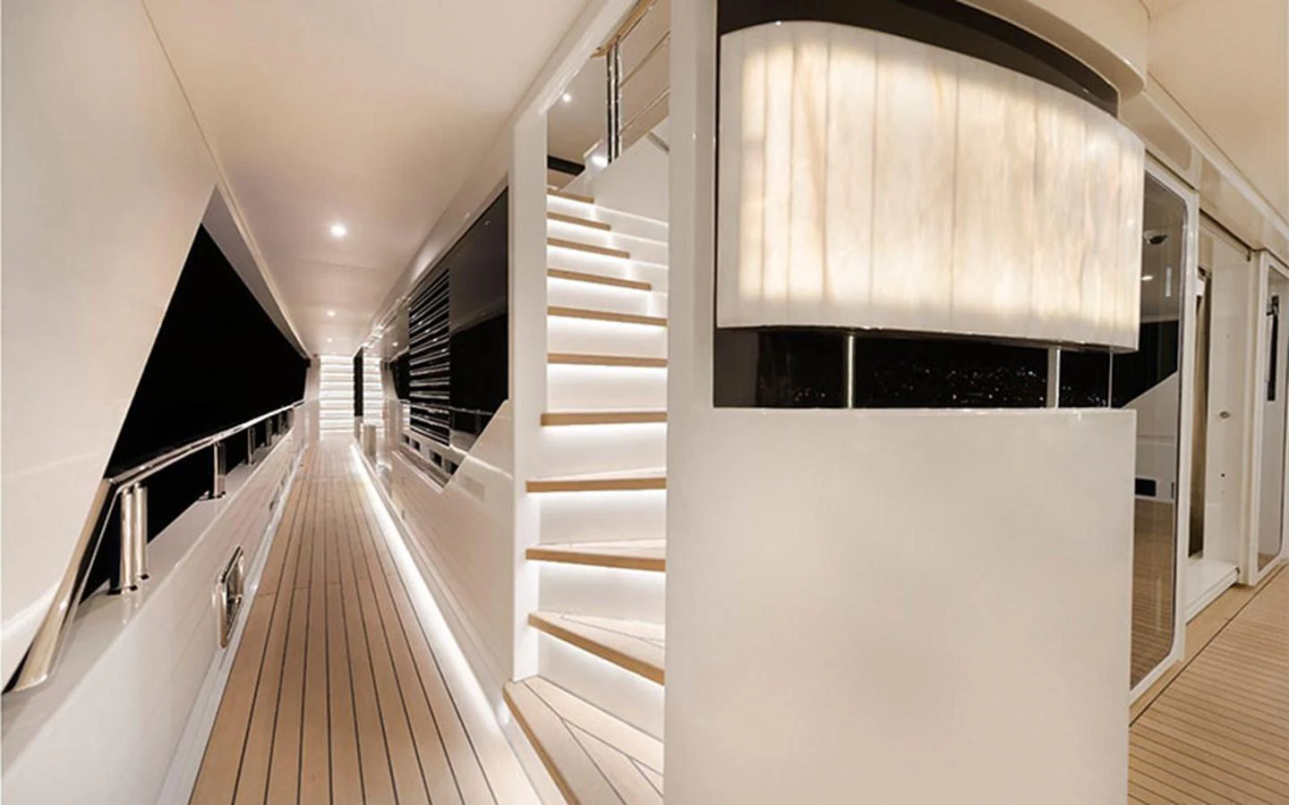 A sleek and modern hallway with elegant lighting and wooden flooring. aboard CMB  108 Yacht for Sale