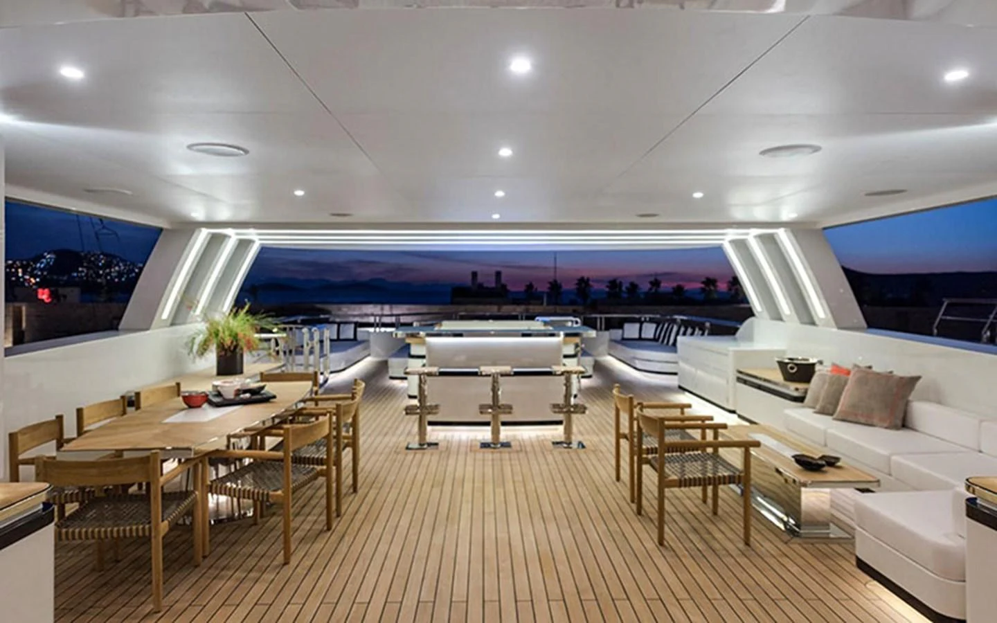 The aft deck offers a spacious and elegantly lit area for dining and relaxation with a stunning view. aboard CMB  108 Yacht for Sale