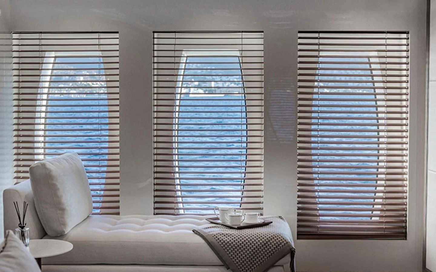 The serene interior features large windows with blinds, offering a view of the sea. aboard CMB  108 Yacht for Sale
