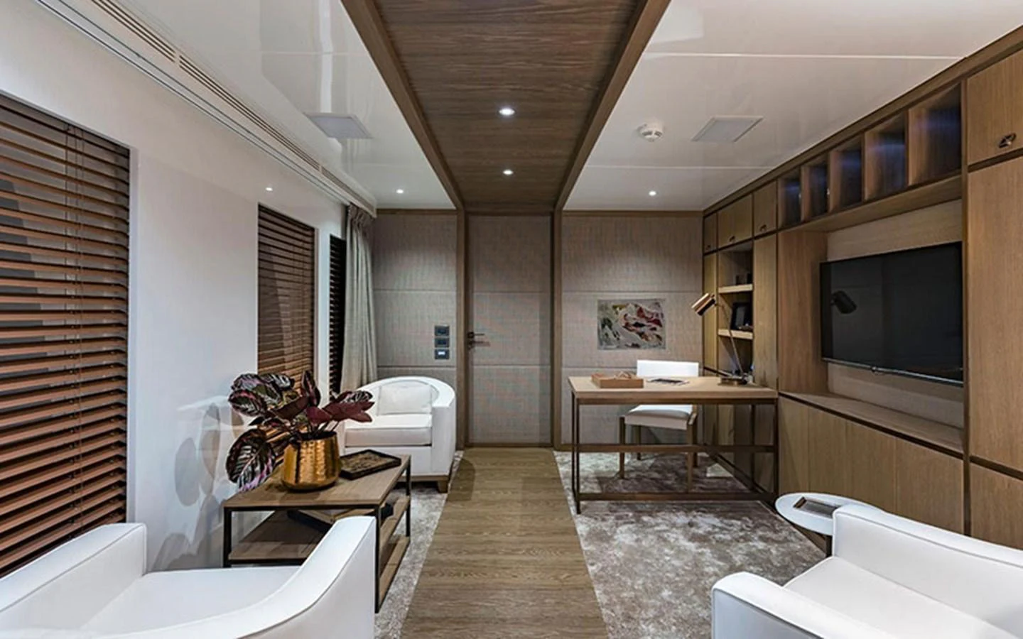 The salon features modern furnishings with a cozy seating area and a built-in entertainment center. aboard CMB  108 Yacht for Sale