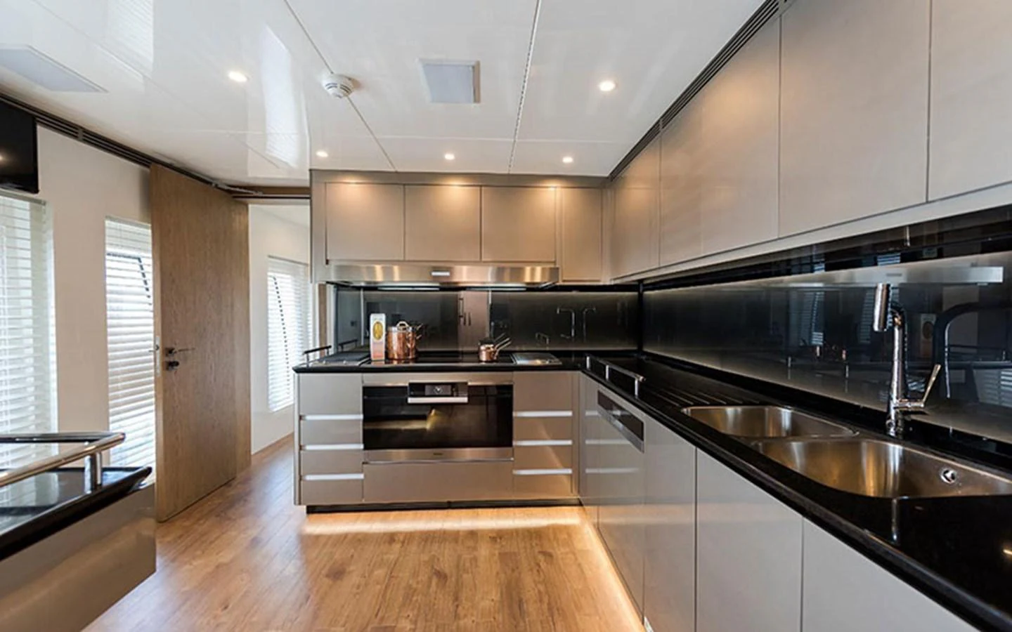 The yacht's galley features modern appliances and sleek cabinetry, creating a stylish and functional cooking space. aboard CMB  108 Yacht for Sale