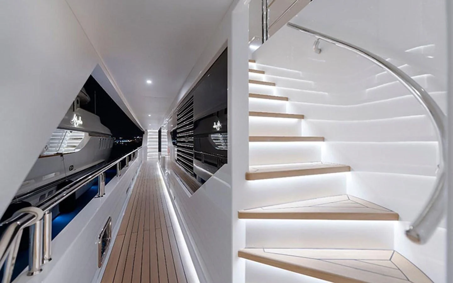A sleek, modern staircase with ambient lighting leads to the upper deck of the yacht. aboard CMB  108 Yacht for Sale