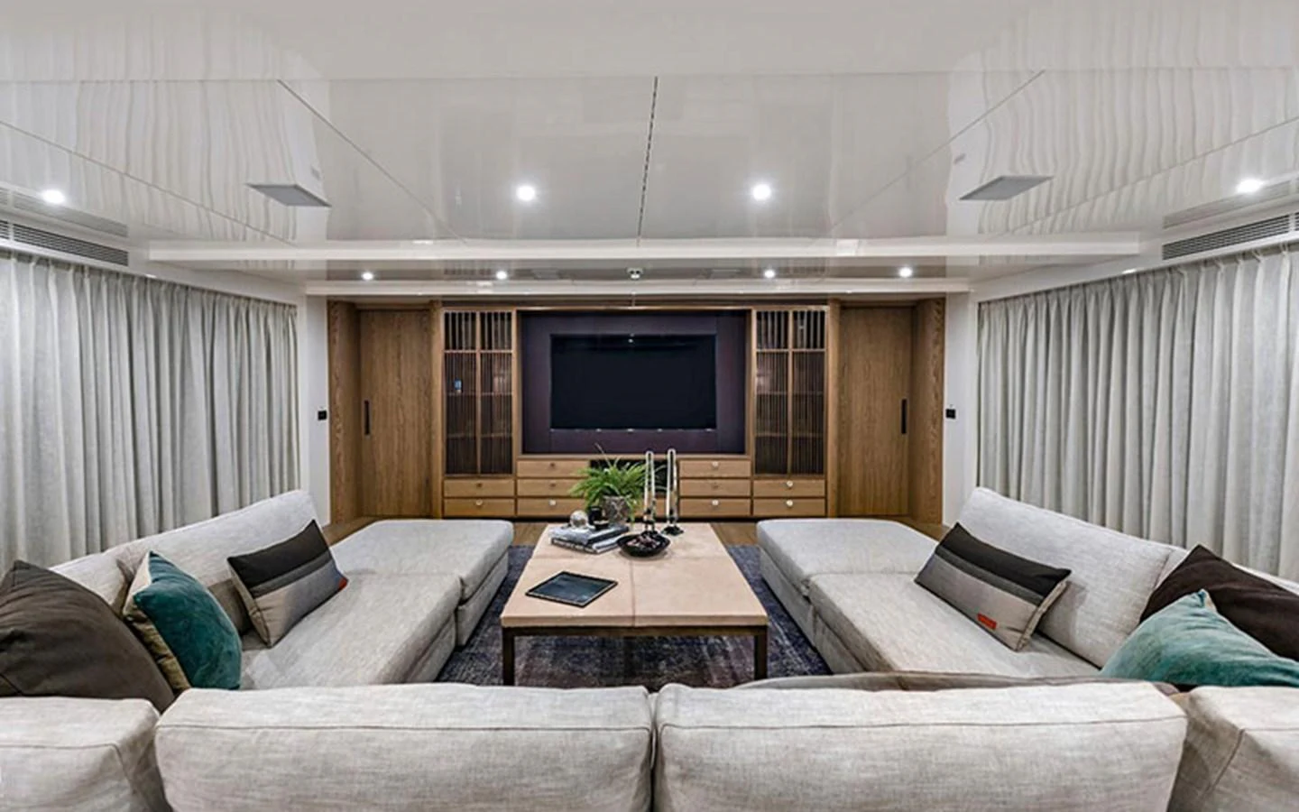 The salon features plush seating, a large TV, and elegant decor for a comfortable and stylish lounging experience. aboard CMB  108 Yacht for Sale