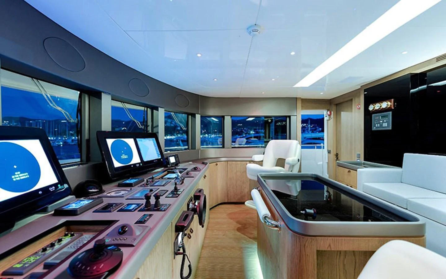 The helm station features state-of-the-art navigation equipment and a comfortable seating area with panoramic views. aboard CMB  108 Yacht for Sale