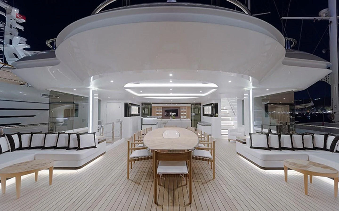 The spacious aft deck features elegant seating and a dining area, perfect for alfresco entertaining. aboard CMB  108 Yacht for Sale
