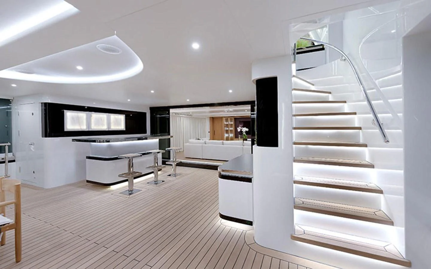 The main salon features a modern, open layout with sleek furnishings and a stylish staircase. aboard CMB  108 Yacht for Sale