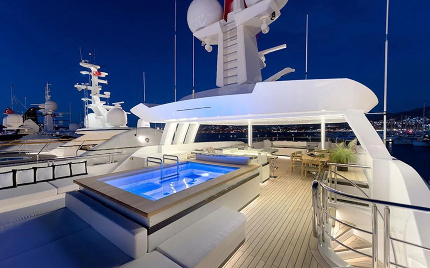 The sundeck features a luxurious pool and ample seating, perfect for evening relaxation. aboard CMB  108 Yacht for Sale