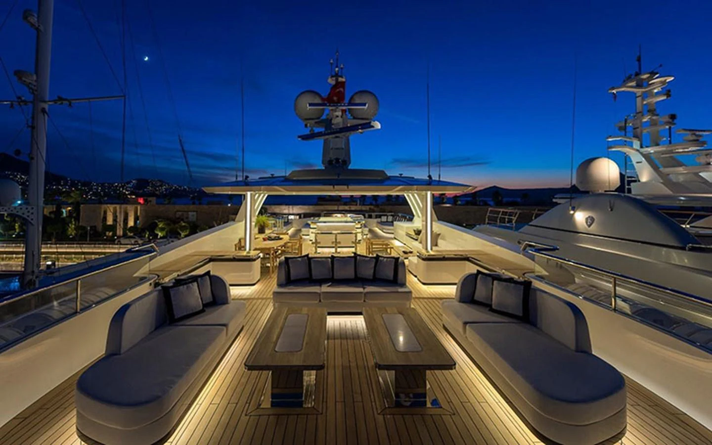 The yacht's sundeck offers a luxurious outdoor seating area with elegant lighting, perfect for evening relaxation. aboard CMB  108 Yacht for Sale