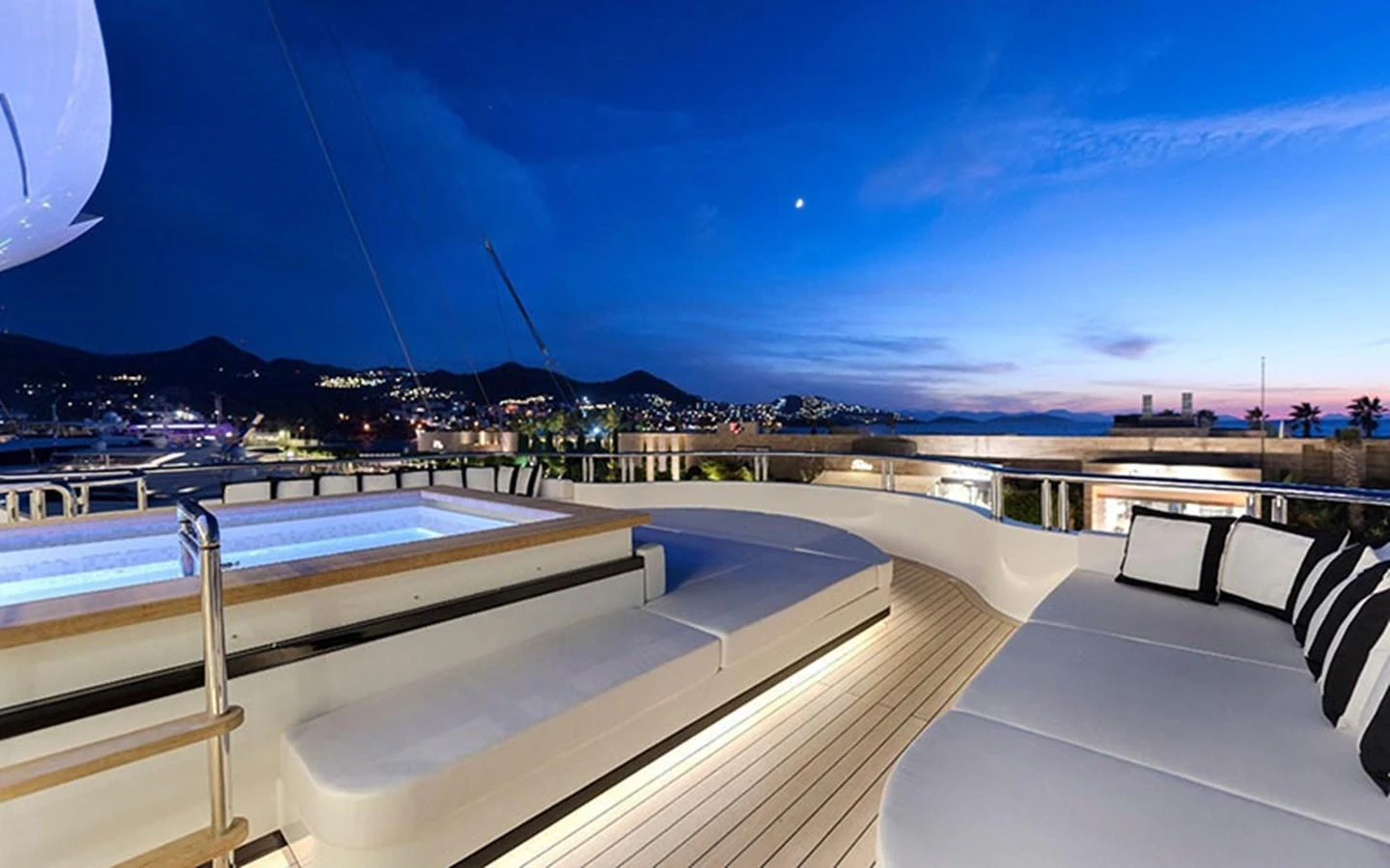 The sundeck features a luxurious hot tub and ample seating with a stunning evening view. aboard CMB  108 Yacht for Sale