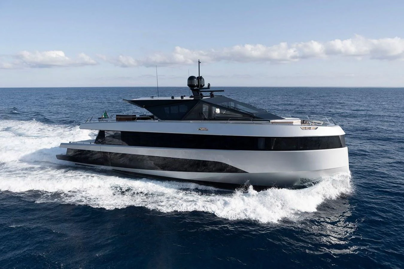 A sleek and modern yacht cruises through the open sea, showcasing its elegant design and powerful performance. aboard CARAT Yacht for Sale