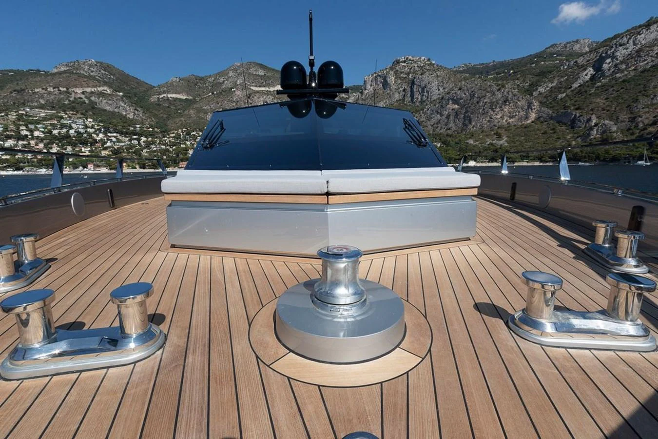 The foredeck of the yacht features sleek, modern design elements with polished metal fixtures and expansive teak decking. aboard CARAT Yacht for Sale