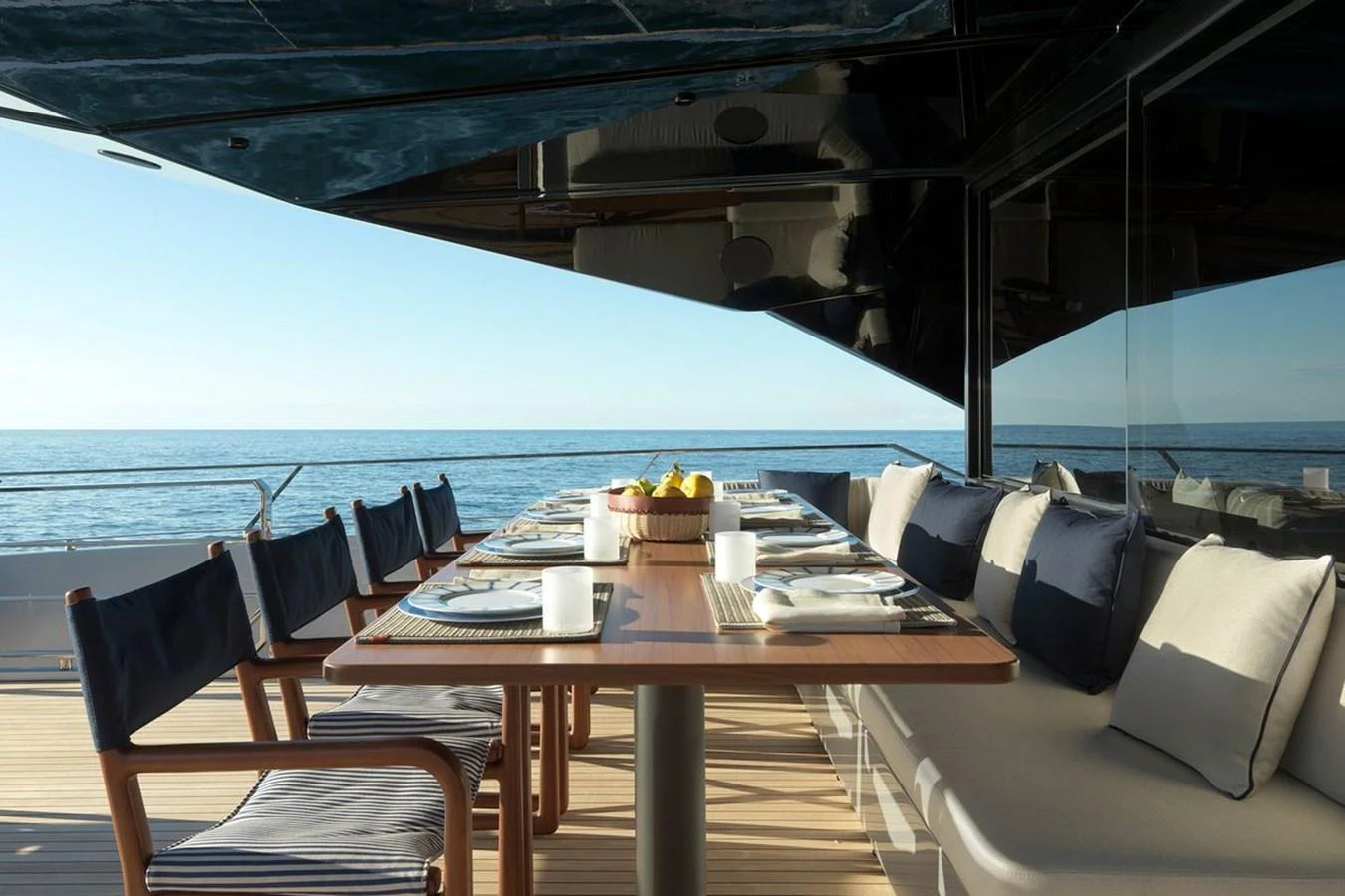 The aft deck features an elegant dining area with a stunning ocean view. aboard CARAT Yacht for Sale