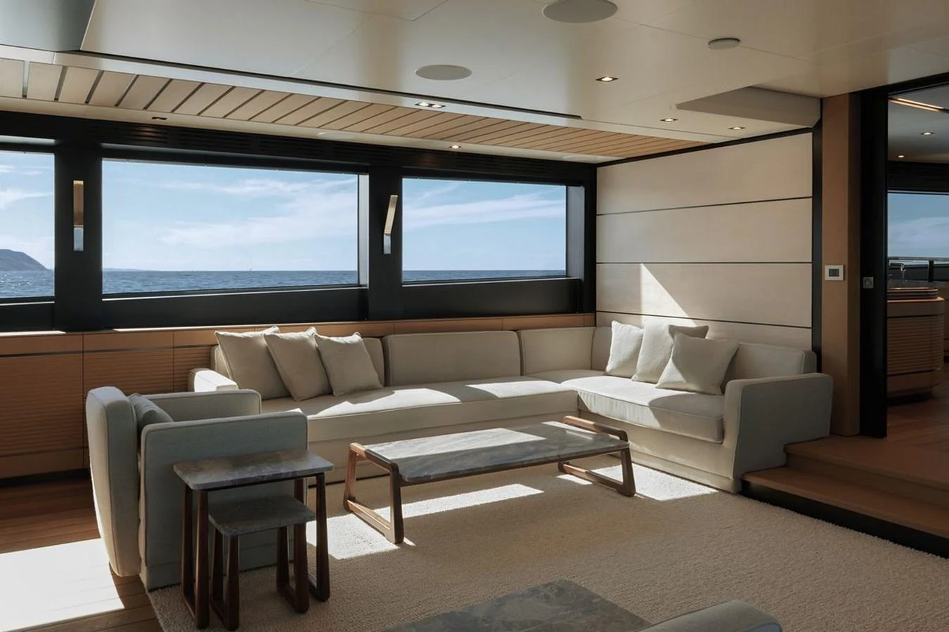 The salon features a spacious and elegant seating area with large windows offering stunning ocean views. aboard CARAT Yacht for Sale