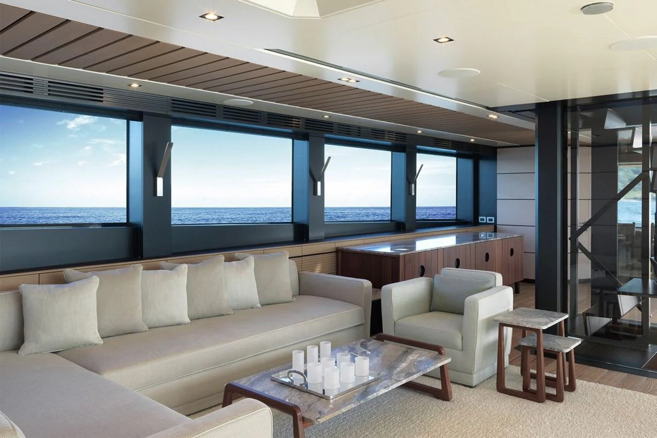 The salon offers a spacious and elegant seating area with panoramic ocean views. aboard CARAT Yacht for Sale