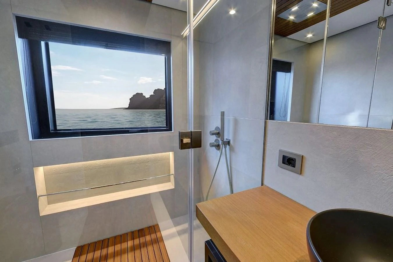 The yacht's bathroom features a sleek design with a large window offering a stunning sea view. aboard CARAT Yacht for Sale