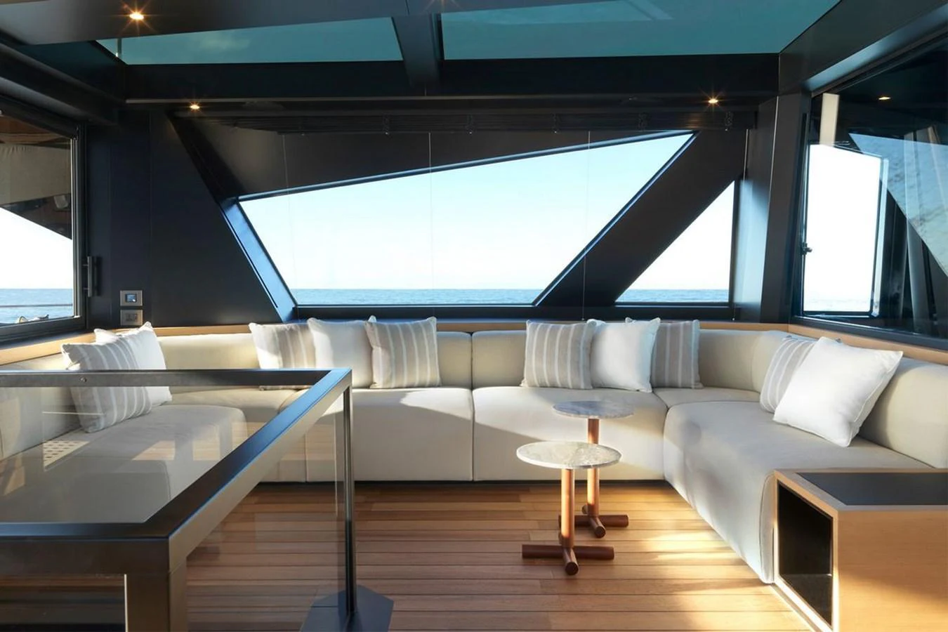 The salon features a spacious seating area with modern decor and panoramic windows. aboard CARAT Yacht for Sale