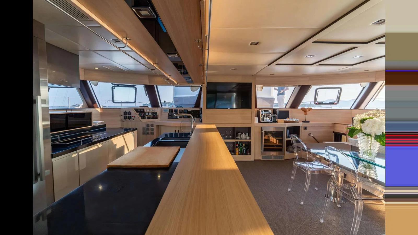The yacht's galley features modern appliances, ample counter space, and a stylish dining area with panoramic windows. aboard SEAZEN II Yacht for Sale