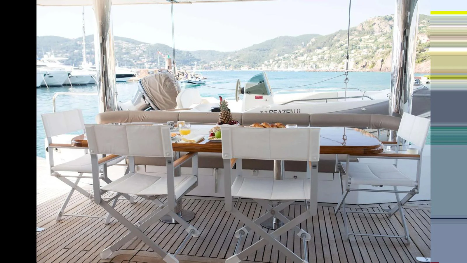 The aft deck features a stylish dining area with a scenic view of the marina. aboard SEAZEN II Yacht for Sale