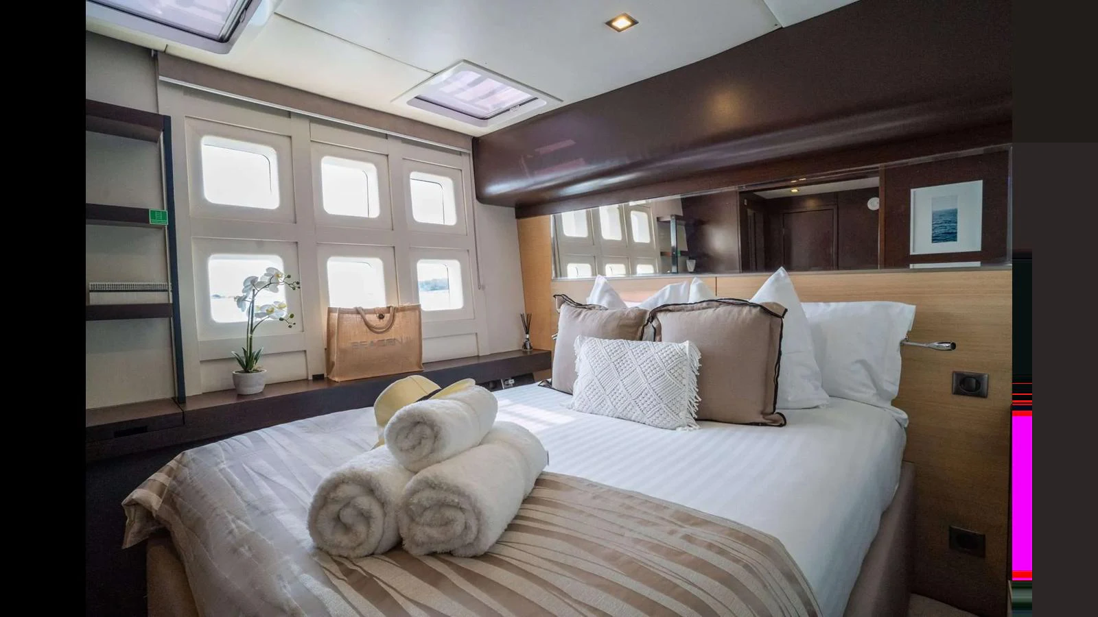 The stateroom features a plush bed with elegant linens and ample natural light from the windows. aboard SEAZEN II Yacht for Sale