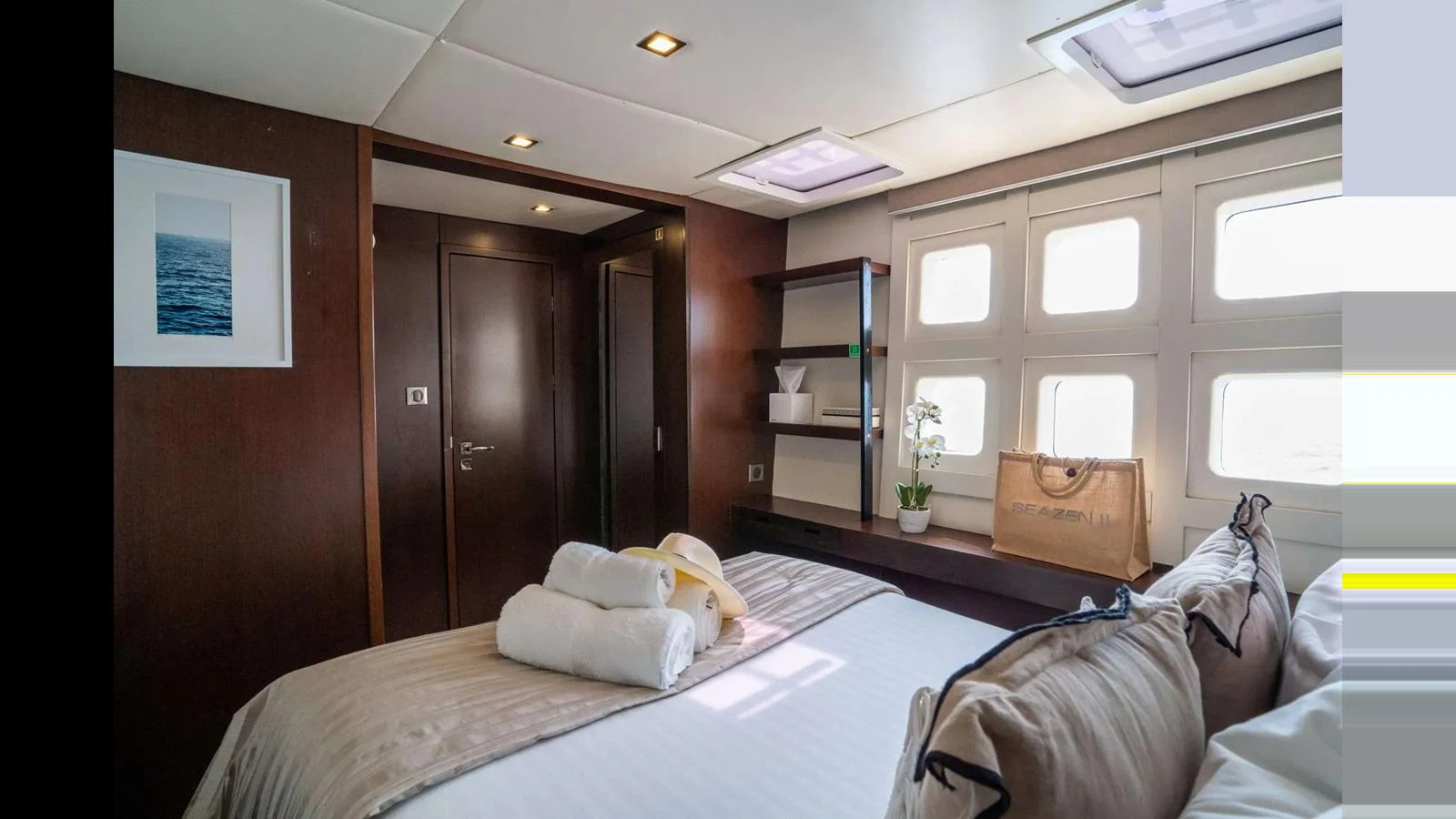 The stateroom offers a cozy and inviting atmosphere with natural light streaming through the windows. aboard SEAZEN II Yacht for Sale