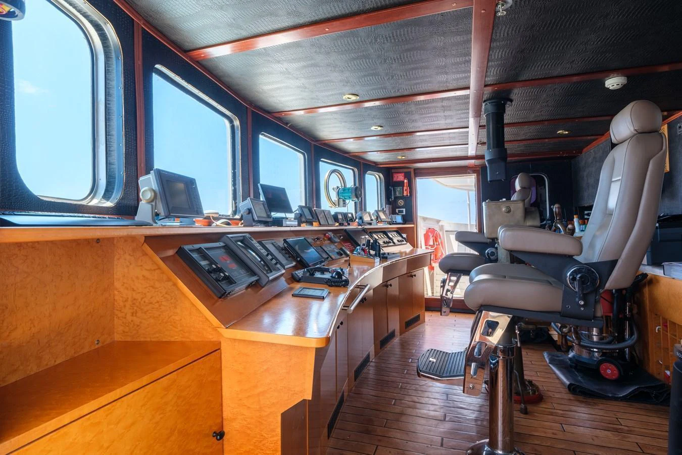 The helm station features advanced navigation equipment and comfortable seating for the captain. aboard HARMONY II Yacht for Sale