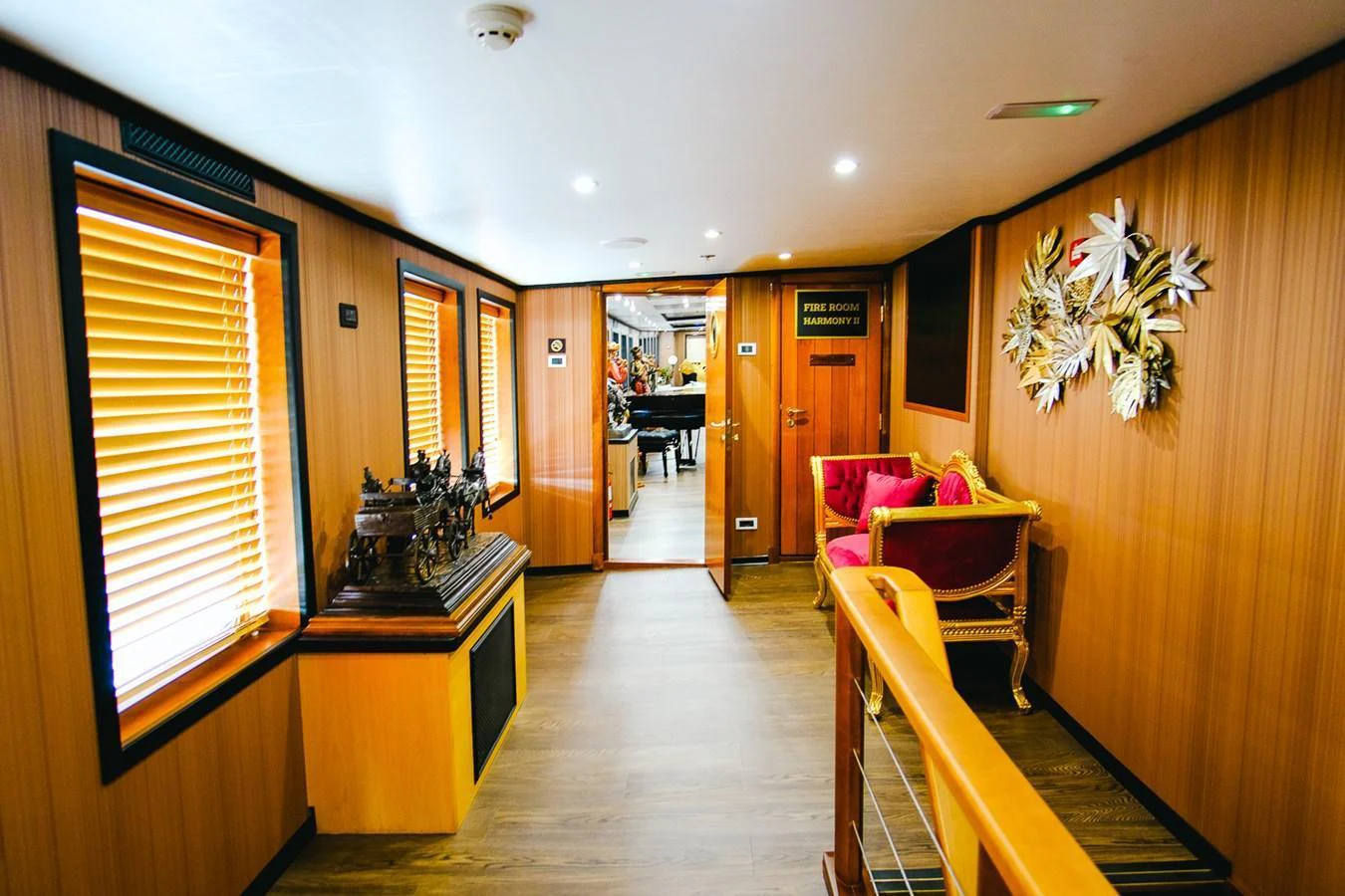 A luxurious yacht interior featuring a hallway with wooden paneling and elegant decor. aboard HARMONY II Yacht for Sale