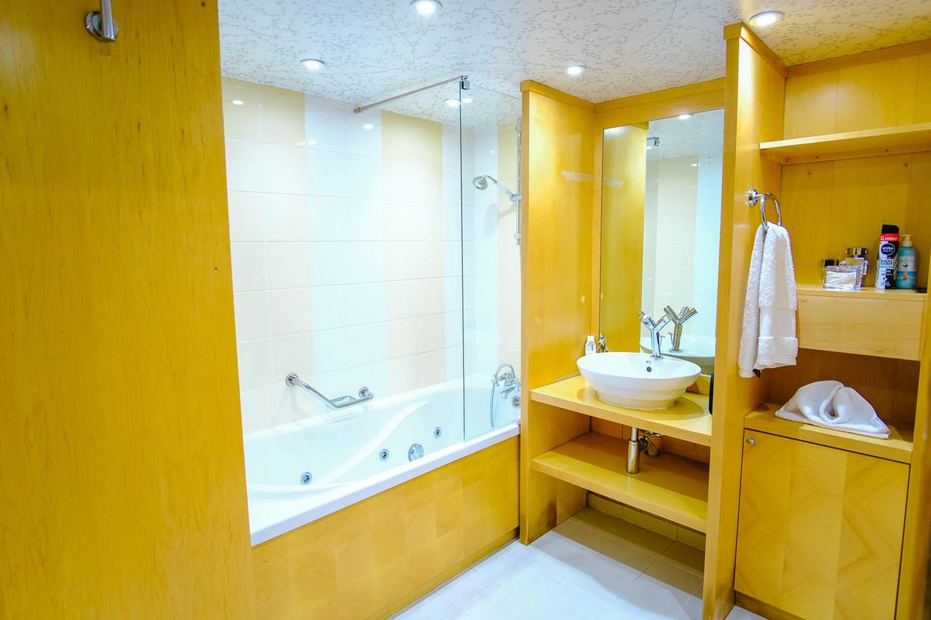 The yacht's bathroom features a modern design with a spacious bathtub and elegant fixtures. aboard HARMONY II Yacht for Sale