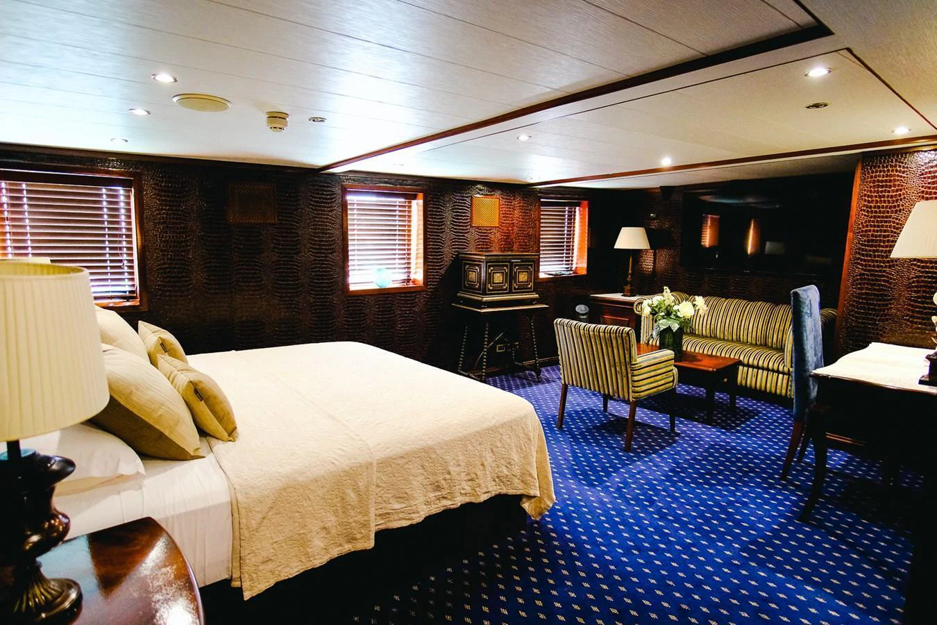 The master stateroom features a spacious bed, comfortable seating area, and elegant decor. aboard HARMONY II Yacht for Sale