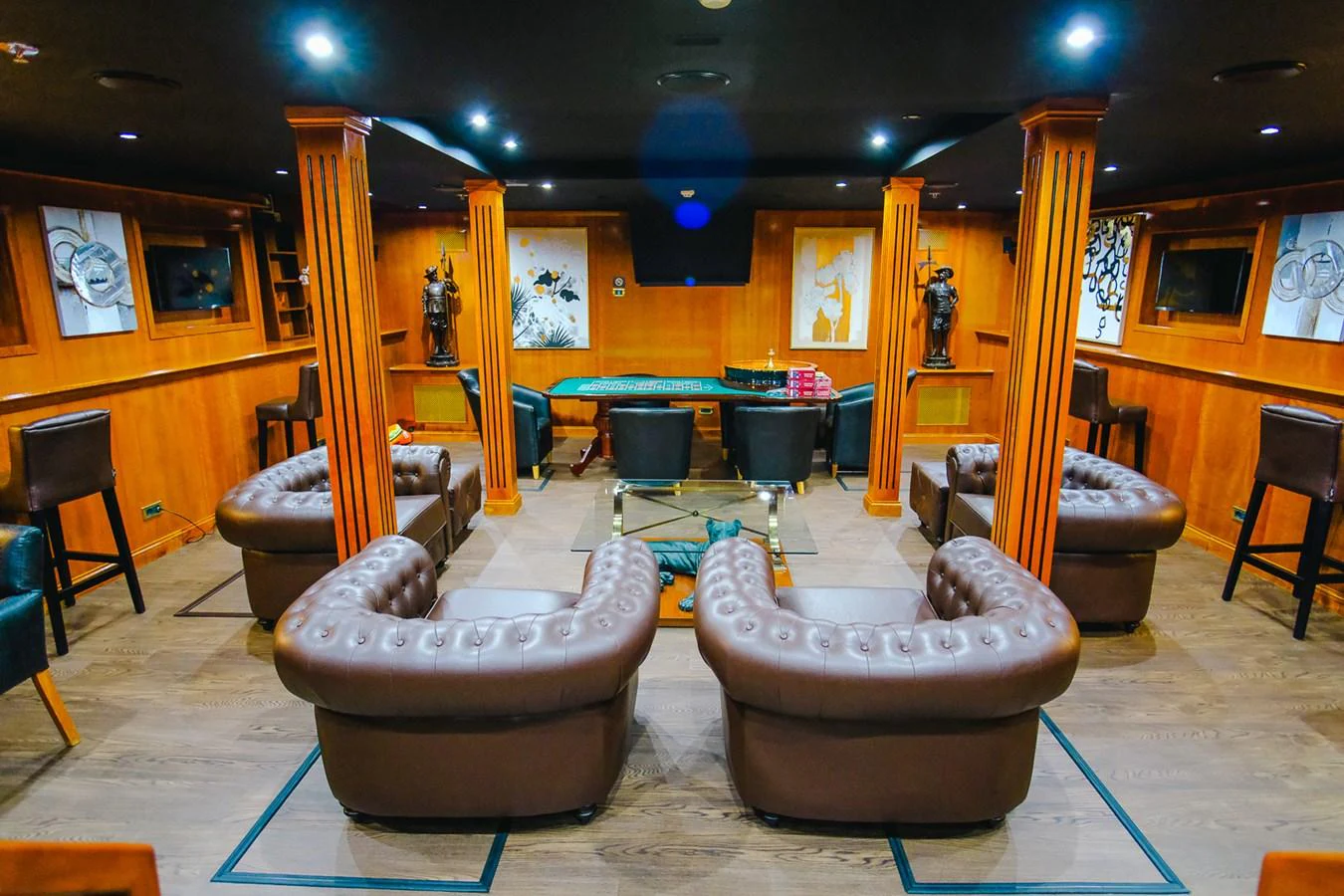 The yacht's interior lounge features luxurious leather seating and elegant wooden accents, creating a warm and inviting atmosphere. aboard HARMONY II Yacht for Sale