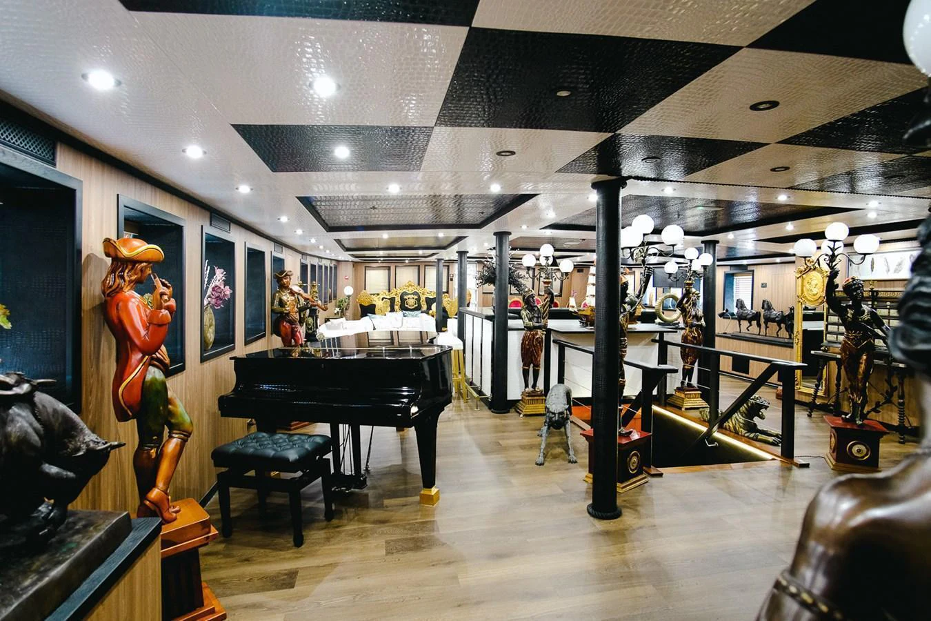 The yacht's interior features a grand piano and eclectic decor, creating a unique and luxurious atmosphere. aboard HARMONY II Yacht for Sale