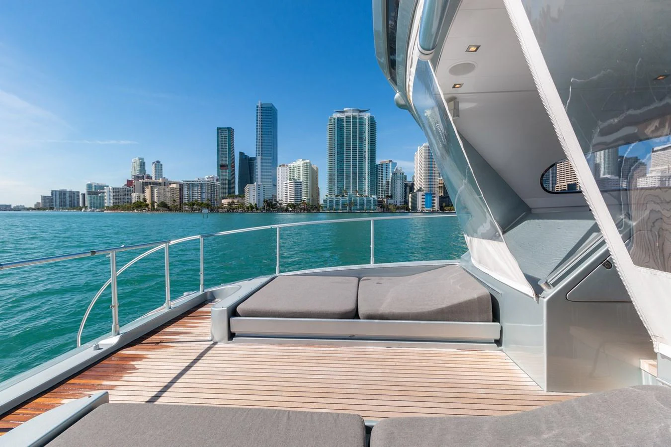 a deck with a view of a city and water aboard HAPPY ONE Yacht for Sale