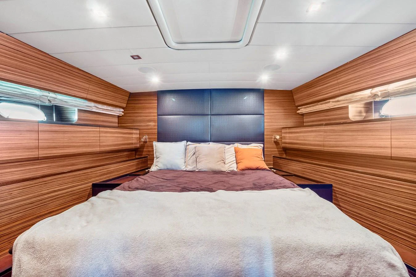 a bed with a red blanket aboard HAPPY ONE Yacht for Sale