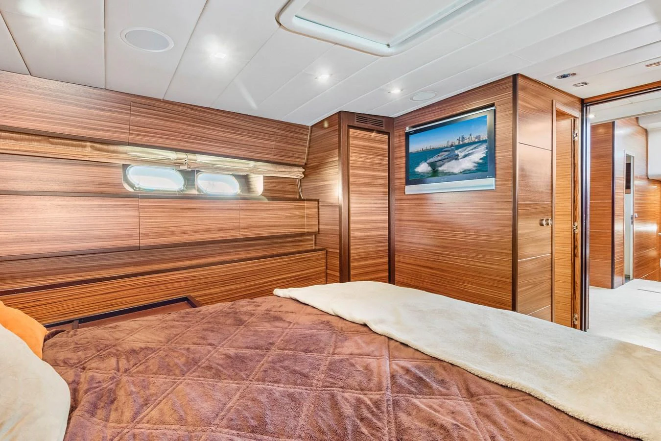 a room with a bed and a television aboard HAPPY ONE Yacht for Sale