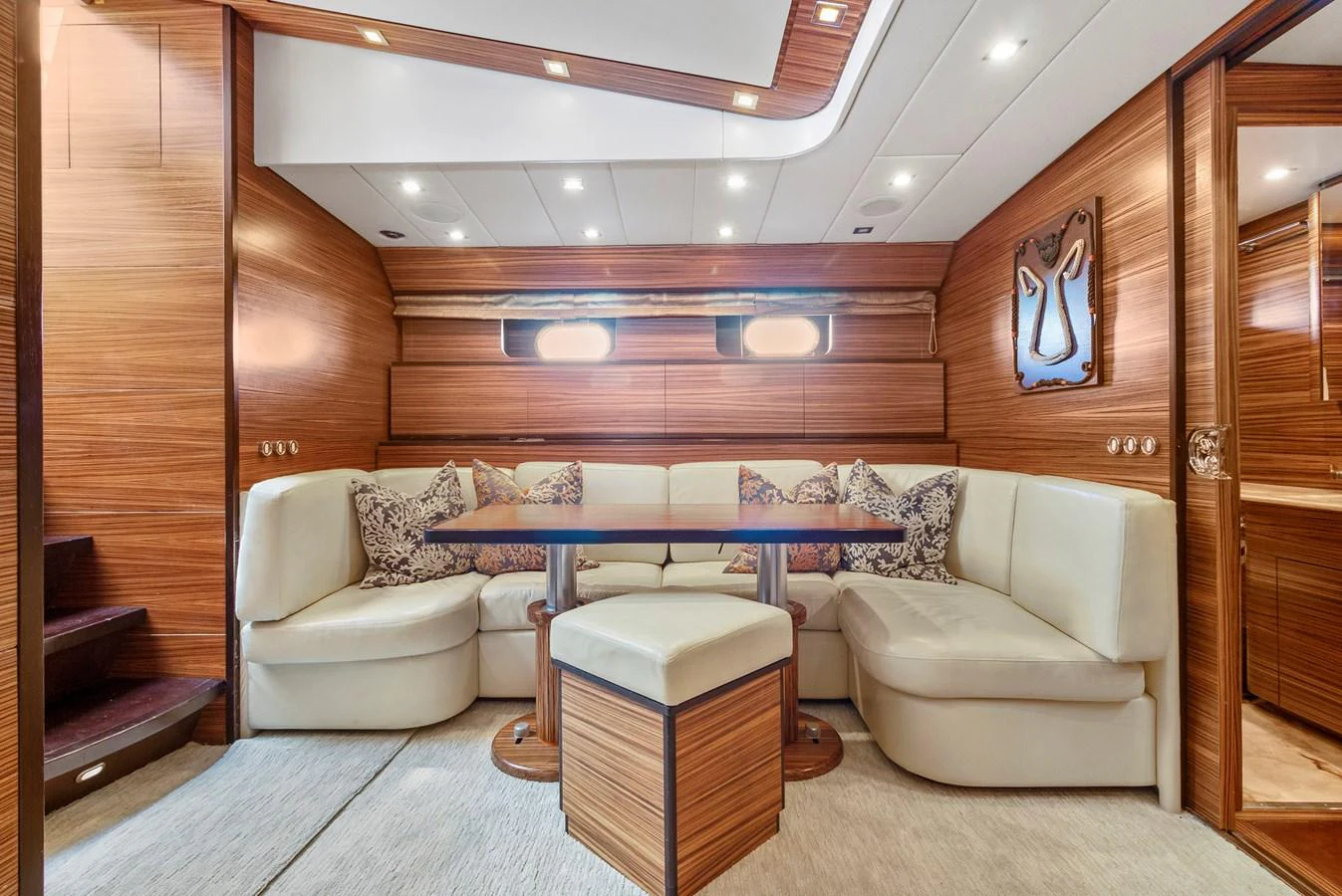 a living room with a table and couches aboard HAPPY ONE Yacht for Sale