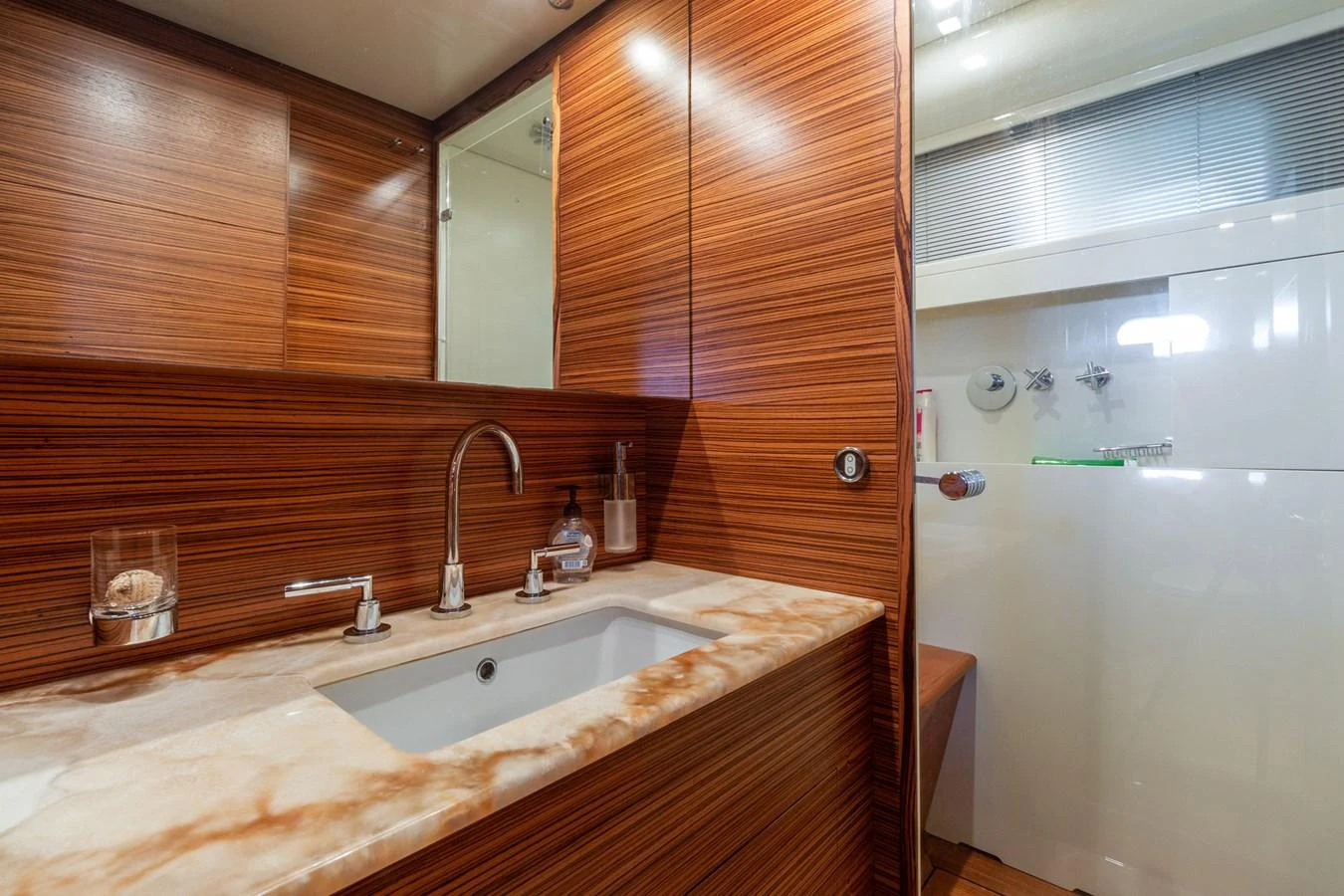 a bathroom with a sink and a shower aboard HAPPY ONE Yacht for Sale
