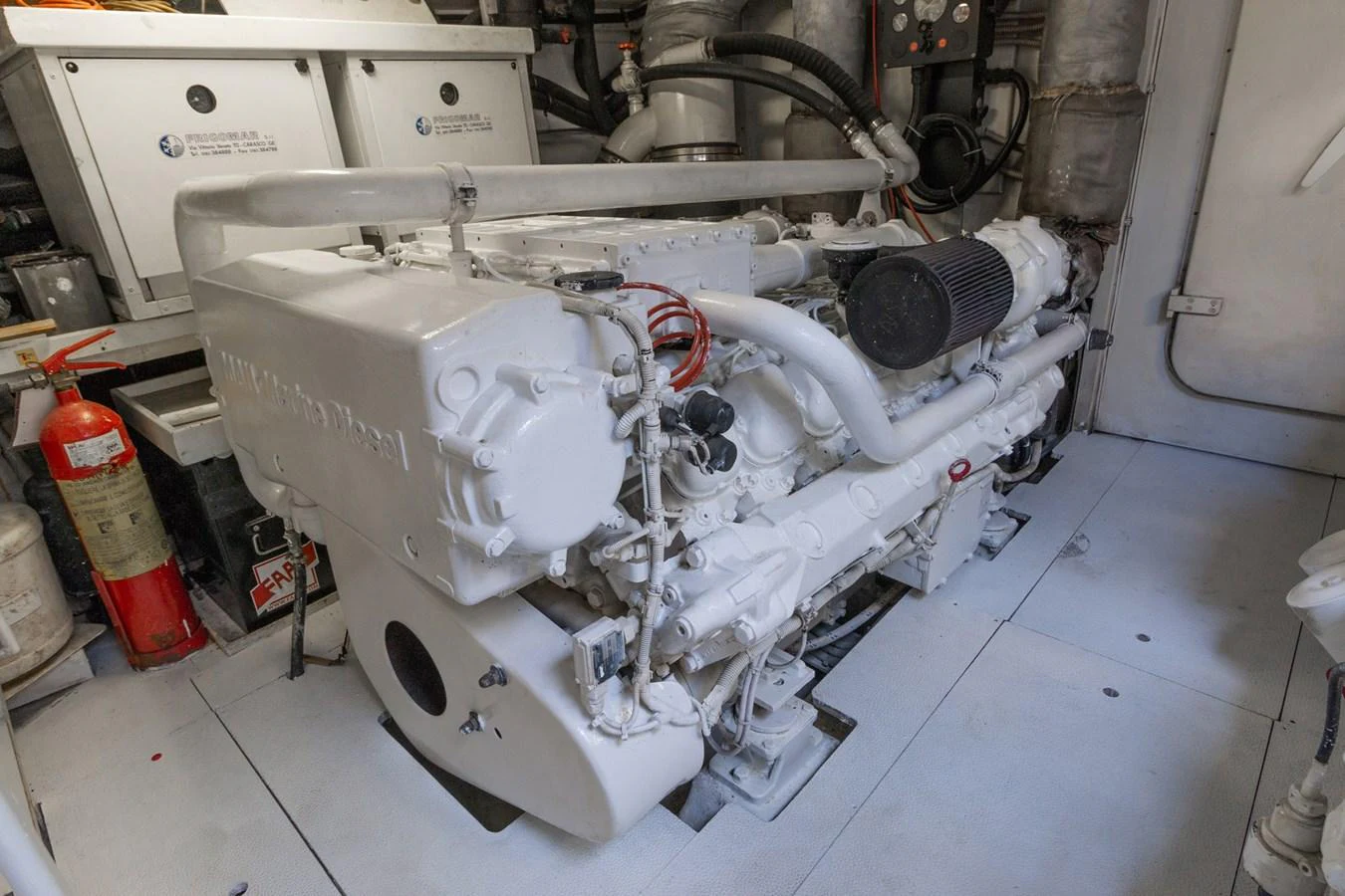 a white machine with a red and black handle aboard HAPPY ONE Yacht for Sale