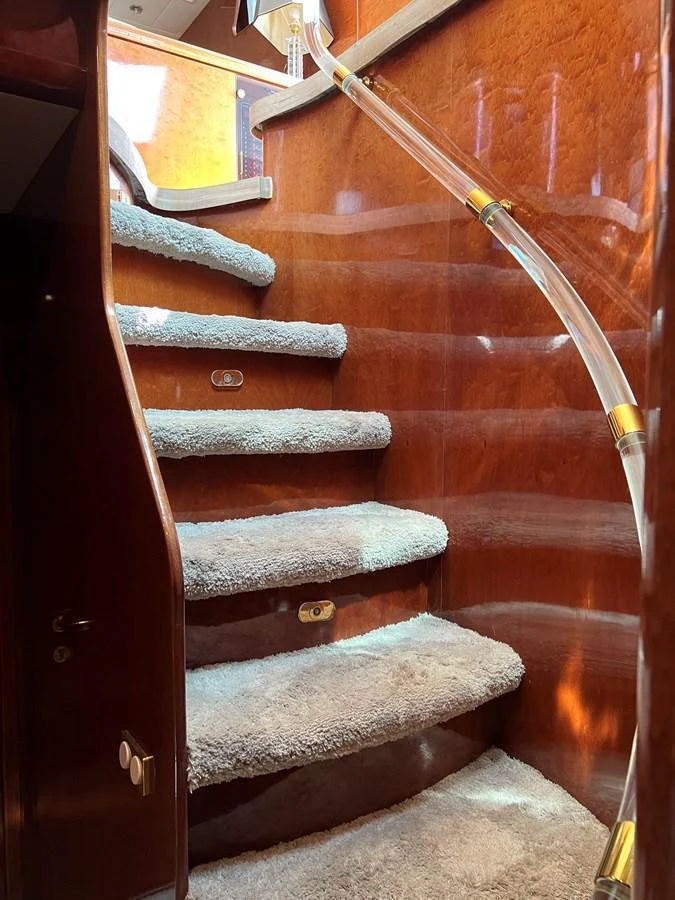 A luxurious staircase with plush carpeting and elegant wood paneling. aboard HORIZON ELEGANCE 82 S Yacht for Sale