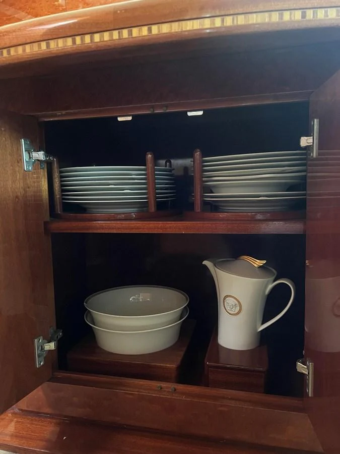 A neatly organized cabinet showcasing fine china and dishware. aboard HORIZON ELEGANCE 82 S Yacht for Sale