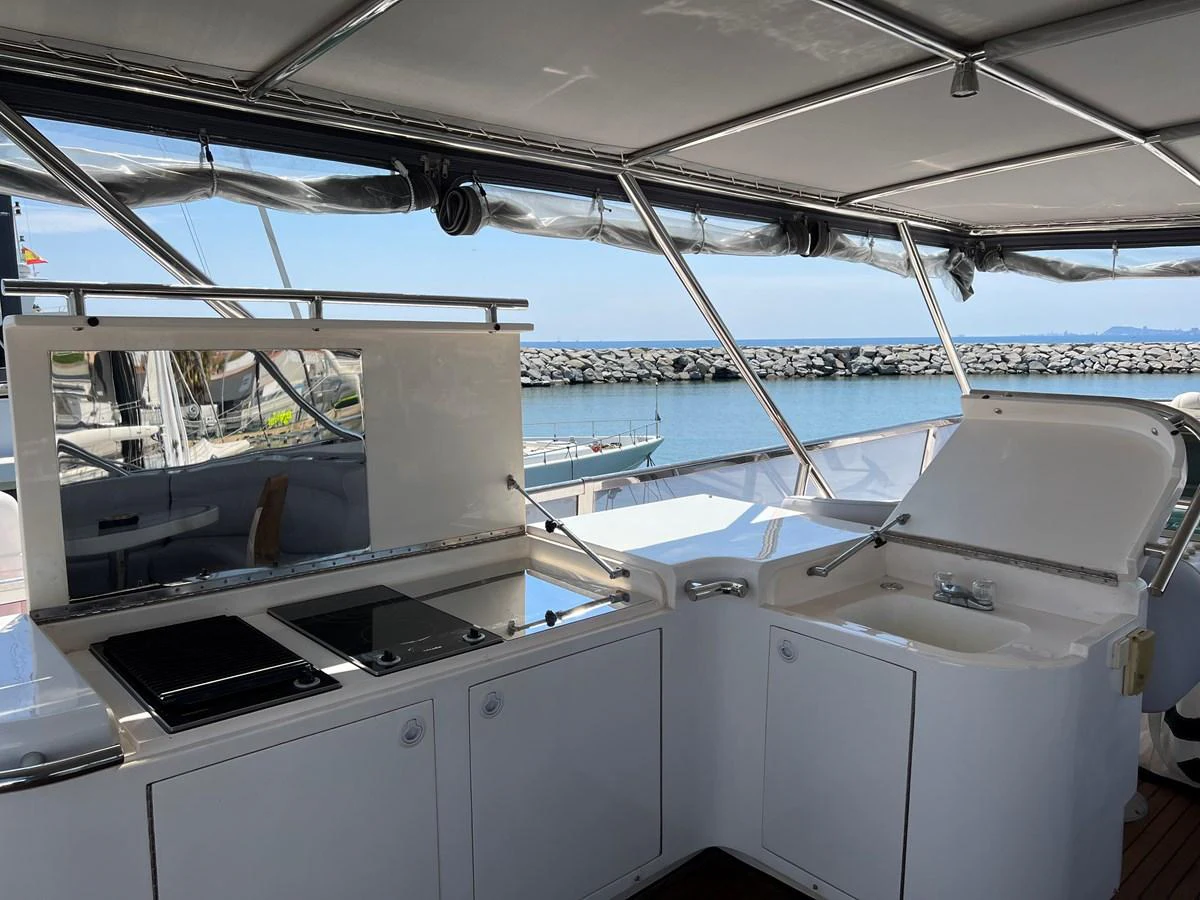 The yacht features a well-equipped outdoor galley with a cooktop and sink, perfect for alfresco dining. aboard HORIZON ELEGANCE 82 S Yacht for Sale