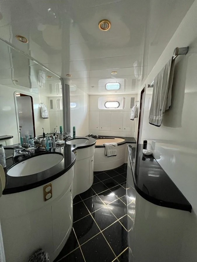 A luxurious yacht bathroom featuring elegant fixtures and a sleek design. aboard HORIZON ELEGANCE 82 S Yacht for Sale