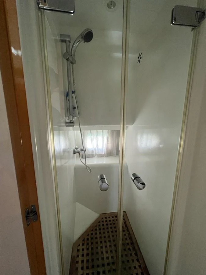 A modern yacht shower with glass doors and sleek fixtures. aboard HORIZON ELEGANCE 82 S Yacht for Sale