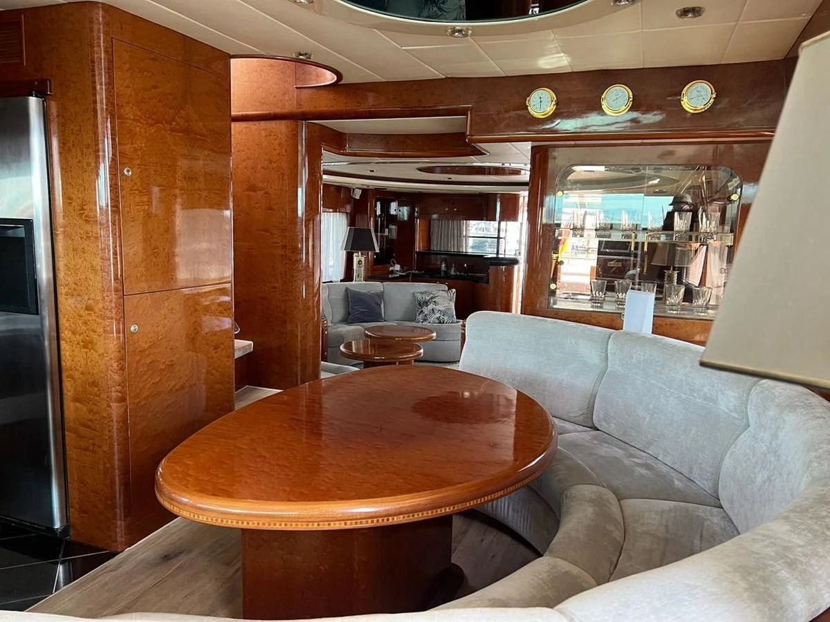 The yacht's salon features elegant wood finishes, plush seating, and a cozy dining area. aboard HORIZON ELEGANCE 82 S Yacht for Sale