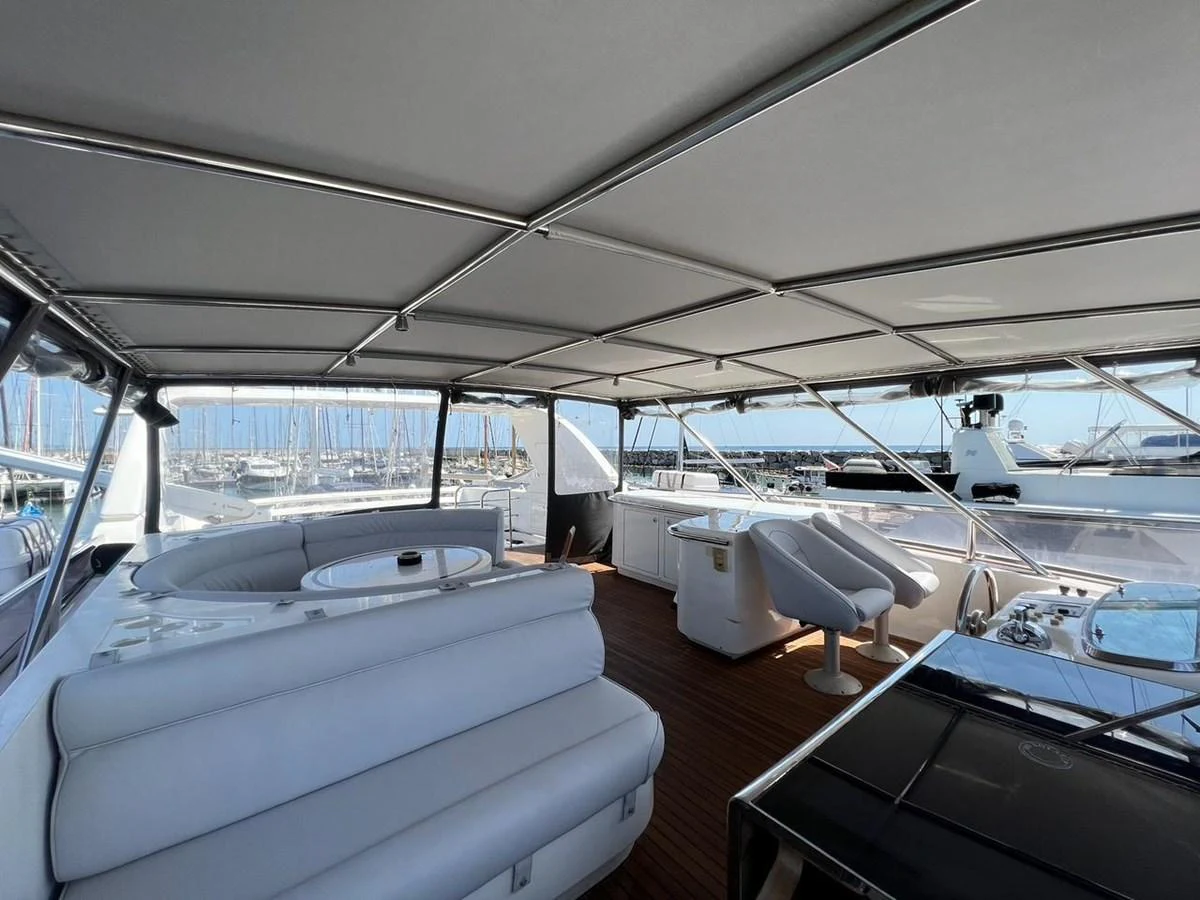 The flybridge offers a spacious and comfortable area with ample seating and a panoramic view of the marina. aboard HORIZON ELEGANCE 82 S Yacht for Sale