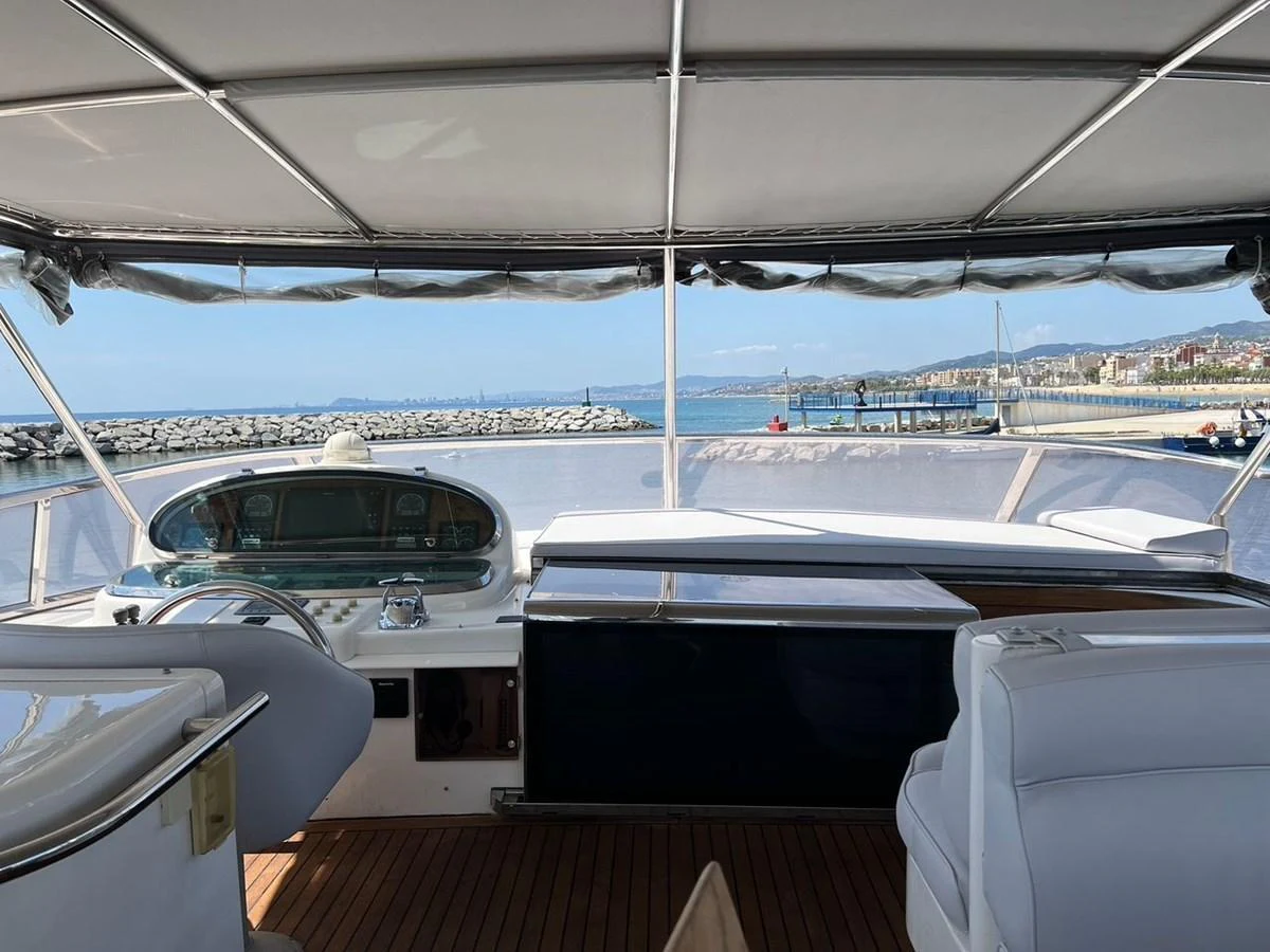 The flybridge offers a spacious and shaded area with comfortable seating and a panoramic view of the marina. aboard HORIZON ELEGANCE 82 S Yacht for Sale